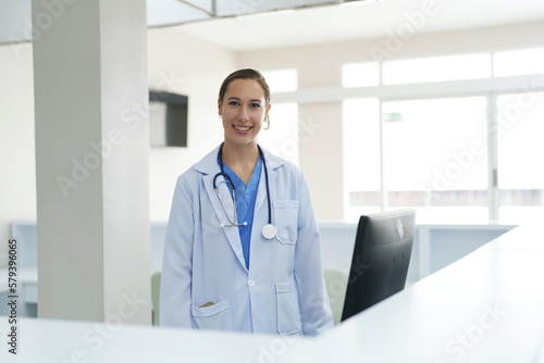 Portrait of female doctor standing in her office at clinic