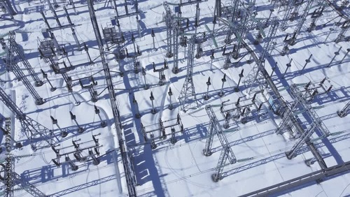 Snow covered electrical high voltage power plant.