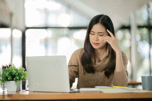 Asian business woman Working on paperwork at the office