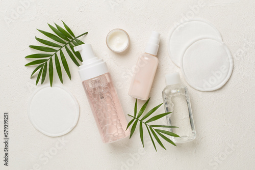 Face care products with eco pads on concrete background  top view