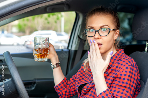 Drunken driving. Drunk woman drives a car. The woman was caught drinking alcohol while driving