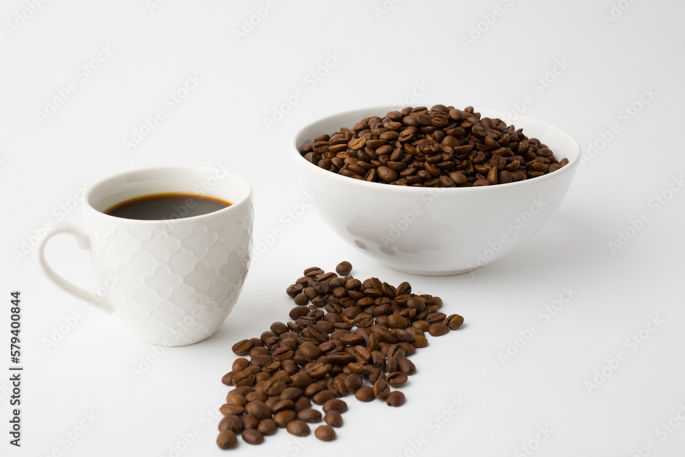 Coffee cup with roasted beans on white background. Top view with copy space Coffee cup with roasted beans on white background. Top view with copy space