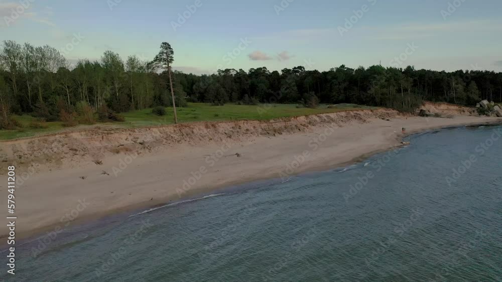 Drone video of sea coastline, erosion and family with dog walking Drone video of sea coastline, erosion and family with dog walking