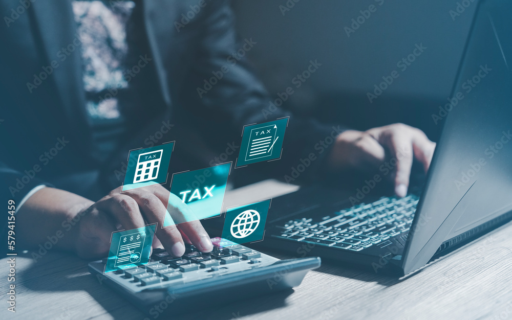Businessman using the laptop to fill in the income tax online return form for payment, Financial research,government taxes and calculation tax return concept. Businessman using the laptop to fill in the income tax online return form for payment, Financial research,government taxes and calculation tax return concept.