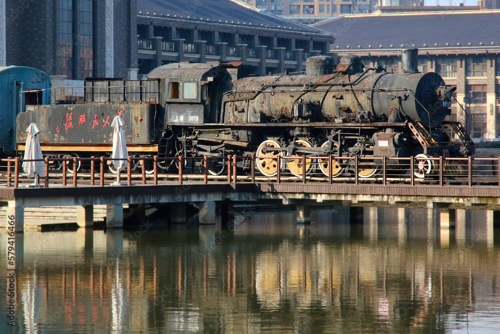 Old rusting Chinese Steam Train with 'Service for the People' written on the side
