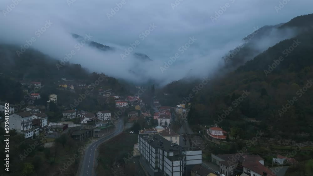 Aerial shot of Caldas de Gerez in a cloudy day full of fog surrounded by the valley, in Peneda Gerês, Portugal Aerial shot of Caldas de Gerez in a cloudy day full of fog surrounded by the valley, in Peneda Gerês, Portugal