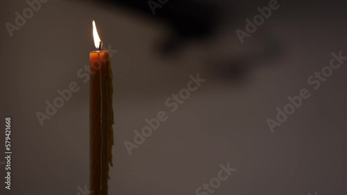 Closeup shot of a lighting candle on a blurred background photo