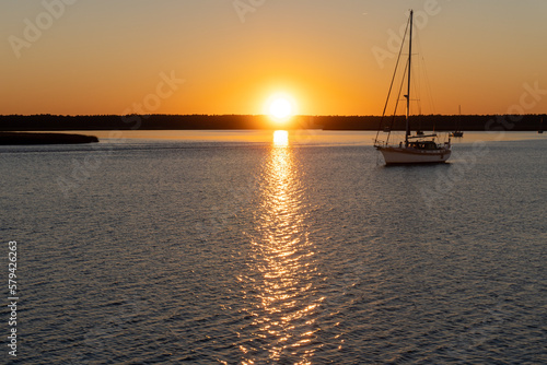 Sunset on the St. Marys River, border between Georgia and Florida near Atlantic Ocean. Sailboats at anchor.  © EWY Media