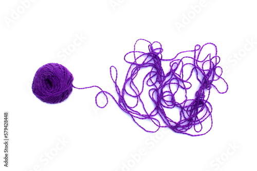 фотографія Entangled threads with a ball lie on a white background.