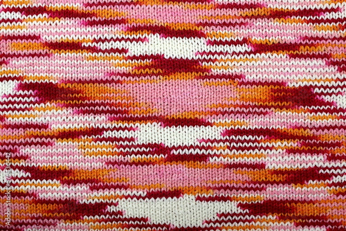 Abstract knitted texture from red  pink and white flowers.  
