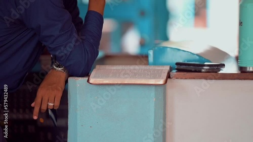 Person reading the Bible during the mass in a church photo