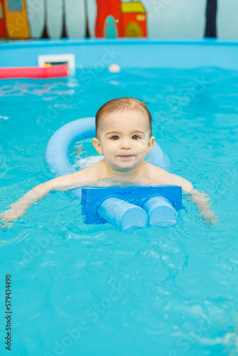 Little boy 2 years old are in the pool. Swimming lessons for young children. © Дмитрий Ткачук