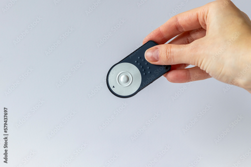 The remote button for the camera in a woman's hand. Copy space The remote button for the camera in a woman's hand. Copy space
