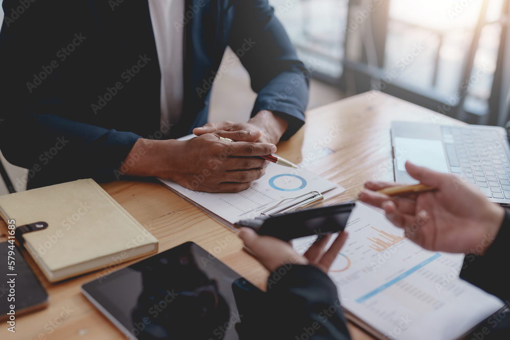 Business people meeting pointing graph and chart to analyze financial and marketing investment. Business people meeting pointing graph and chart to analyze financial and marketing investment.