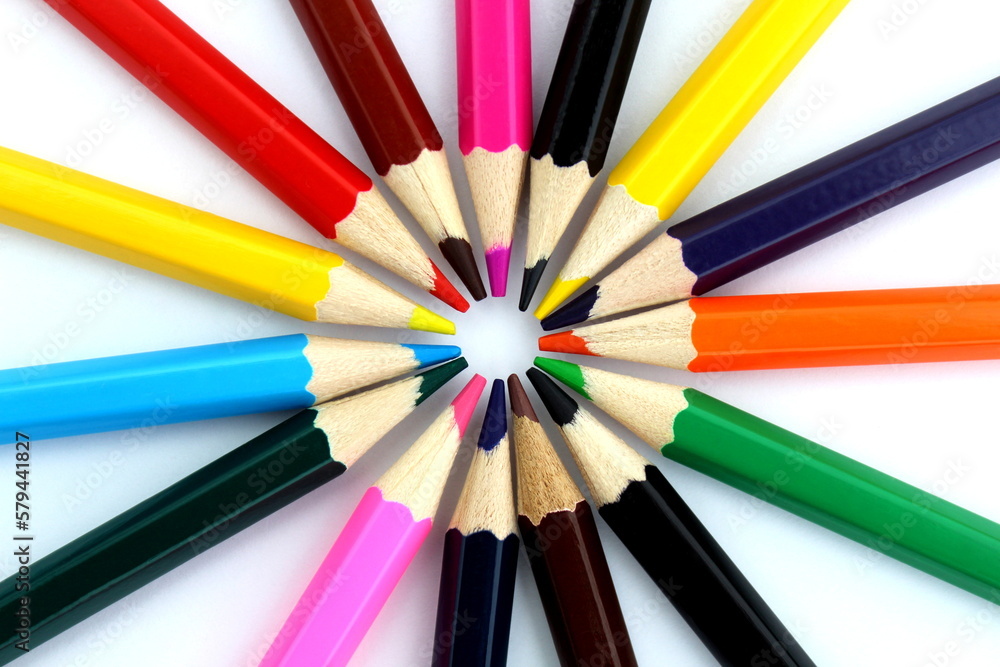 Bright multi-colored pencils lie on a white isolated background. Bright multi-colored pencils lie on a white isolated background.