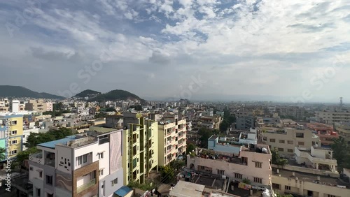 Sityscape of Visakhapatnam city with high apartment buildings under a blue sky in India photo