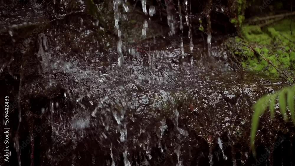 Closeup of a small natural waterfall at the Ngoc Son Buddhist Temple in Hanoi, Vietnam