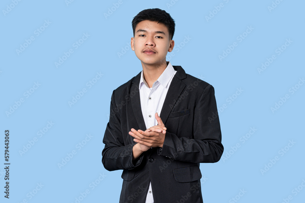 Young handsome asian businessman smiling proud clapping isolated on blue light background Young handsome asian businessman smiling proud clapping isolated on blue light background