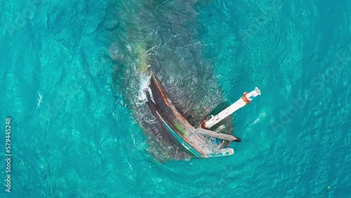 Aerial top view a wreck of a ship sunk in the shallow waters of and now abandoned to bad weather in Keyodhoo, Maldives