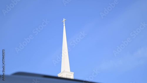 Low angle shot of the church steeple with a blue sky background photo