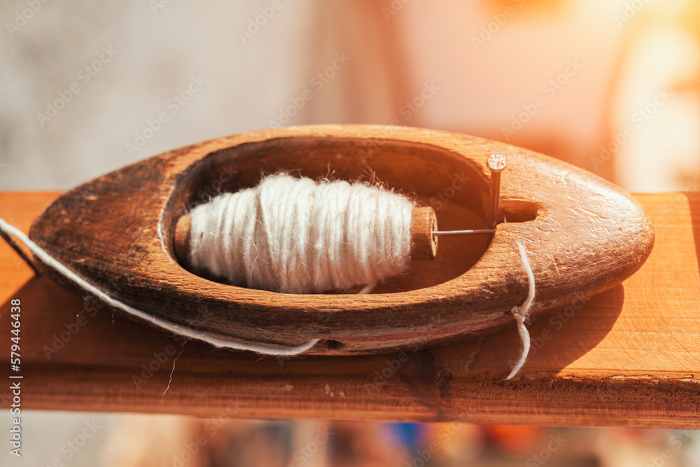 Closeup photo of a vintage wooden boat shuttle for hand weaving. Old