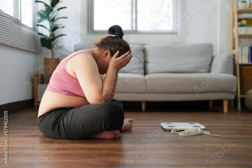 Obraz na plátně Stressful Asian overweight woman sad of dieting Weight loss fail