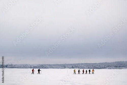 A group of snowshoe tourists walks in the lake in Boden just before the Arctic Circle, Sweden