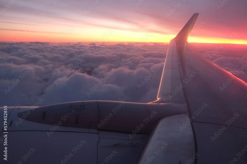 Beautiful views of clouds in sunrise light and sky through the plane window