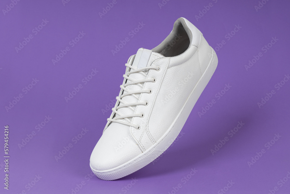 Running sports shoe on purple background. Running shoe, sneaker or trainer. White shoe. fitness, sport, training concept. Running sports shoe on purple background. Running shoe, sneaker or trainer. White shoe. fitness, sport, training concept.
