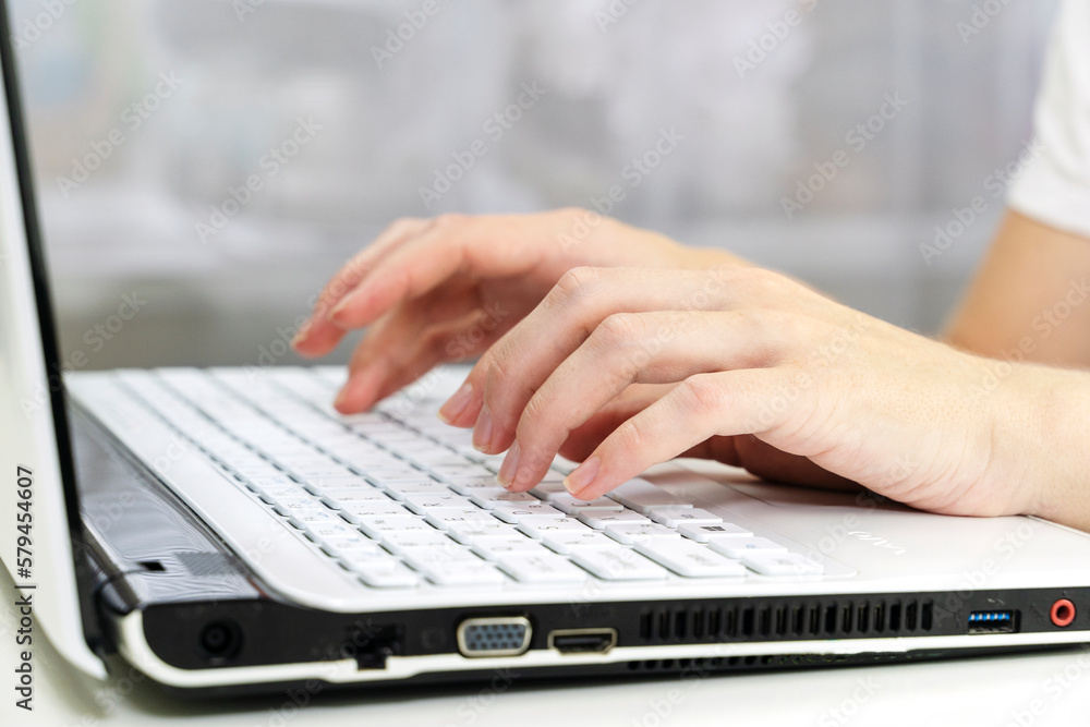 girl's hands on the laptop keyboard girl's hands on the laptop keyboard