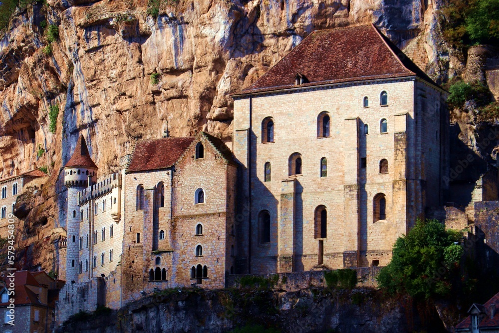 Facade of buildings of Rocamadour built on a rock wall in France