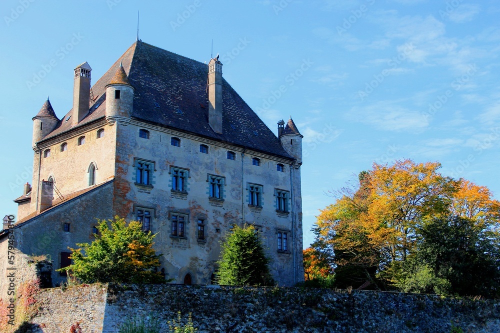 Facade of the Chateau d'Yvoire against a blue cloudy sky
