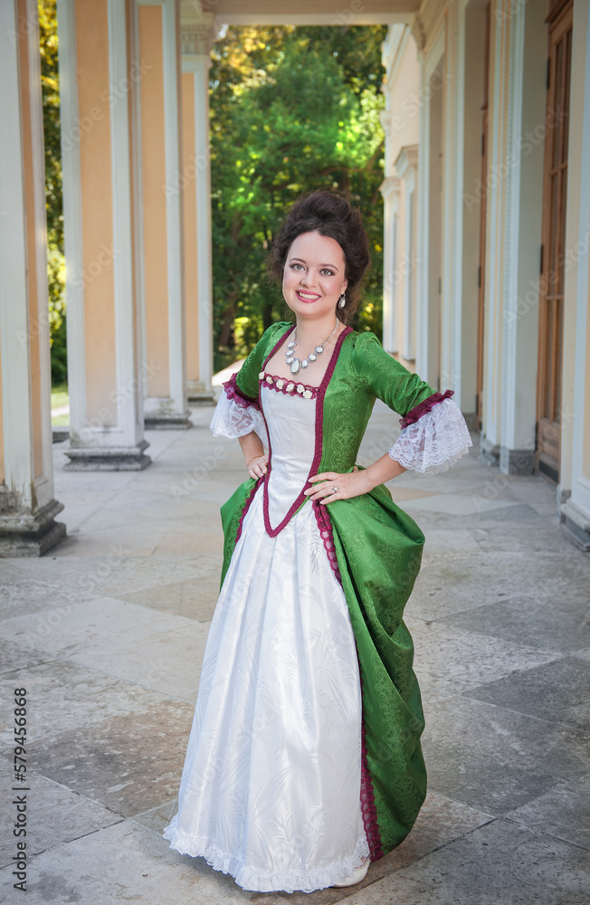 Beautiful young smiling woman in green old-fashioned medieval dress Beautiful young smiling woman in green old-fashioned medieval dress
