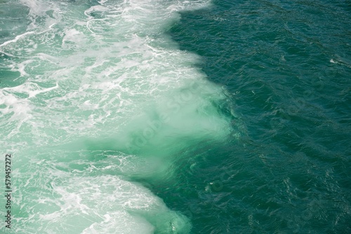 Sea water texture with foam from the thrust of a large propeller.