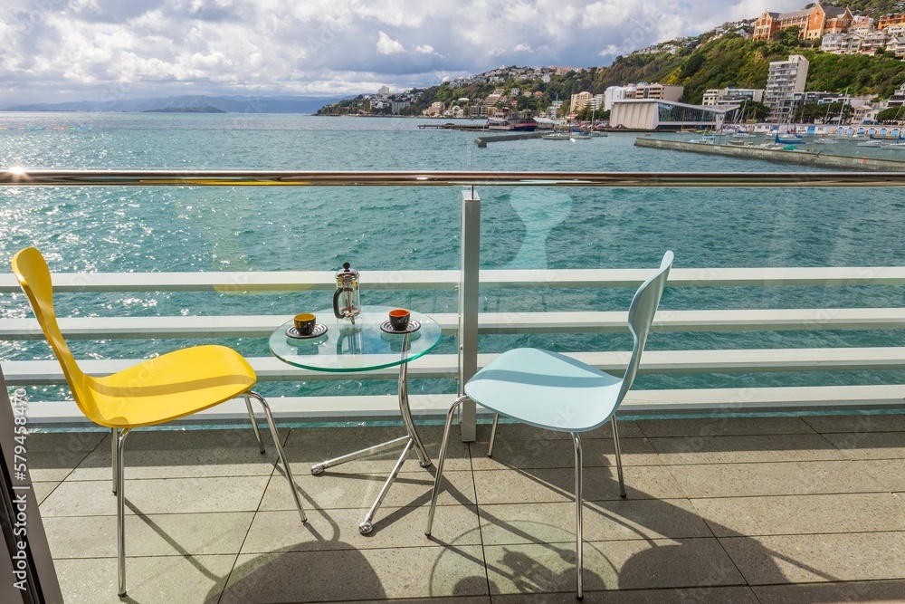 Fototapeta premium View of coffee on the glass table in a luxury hotel overlooking harbor