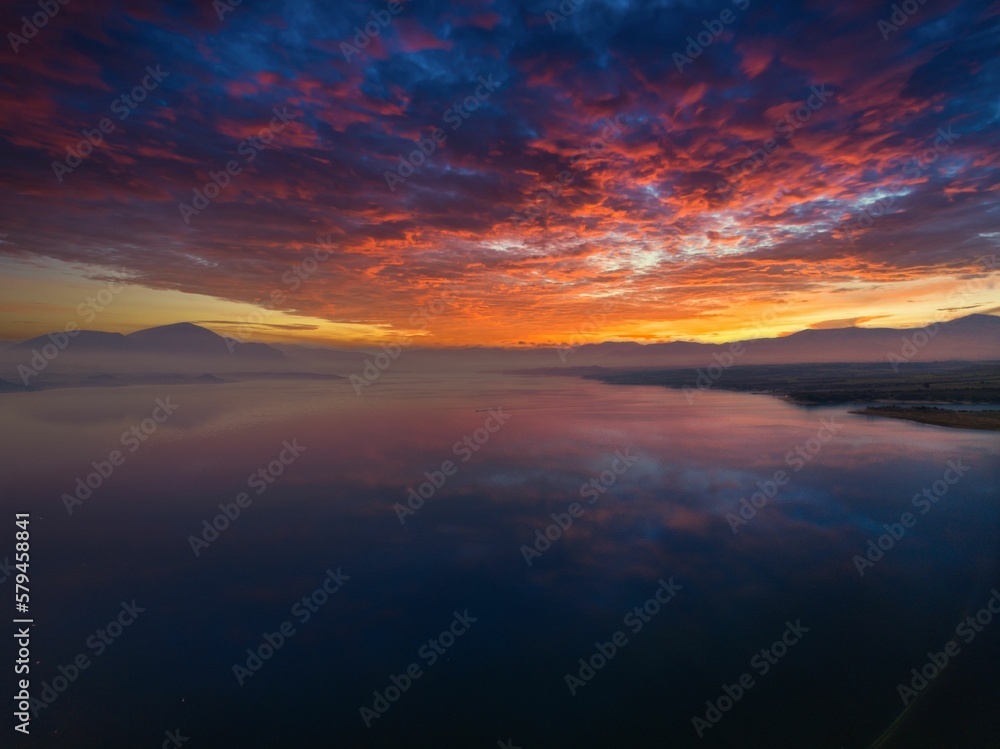 Aerial view of a beautiful sunset seen on the horizon behind the mountains Aerial view of a beautiful sunset seen on the horizon behind the mountains