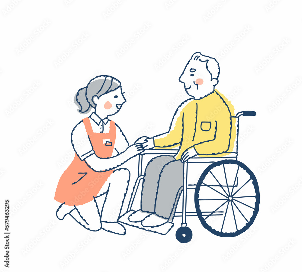 笑顔で話す車いすのシニア男性と介護スタッフ