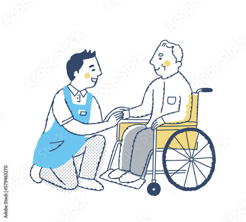 笑顔で話す車いすのシニア男性と介護スタッフ