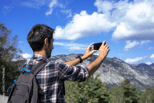 Wallpaper Mural Hiker takes a photo with his mobile phone. Torontodigital.ca