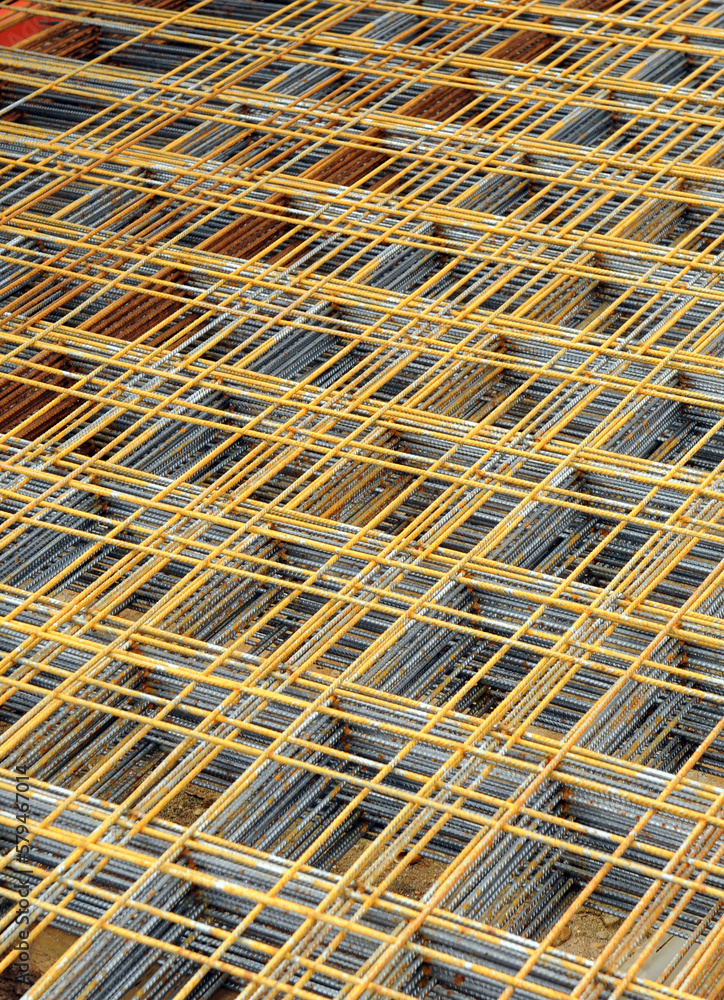 Mesh of steel rods for reinforced concrete construction. Electro-welded rebar mesh stored for works. Construction materials Mesh of steel rods for reinforced concrete construction. Electro-welded rebar mesh stored for works. Construction materials