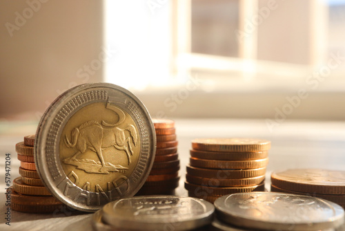 South African currency the Rand. R5 coin standing up against other coins