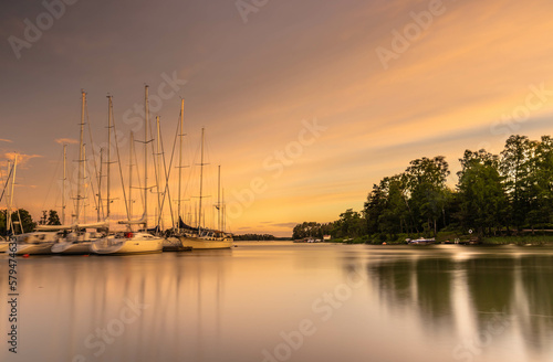 Fototapeta Naklejka Na Ścianę i Meble -  Amazing sunset over the harbor in Finland. A landscape with sunset ,boats in the harbor and an amazing sky that gives a beautiful and fairy-tale atmosphere. 