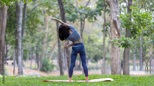 Asian woman doing yoga in nature in the forest, Meditation and breathing exercises, Treat ADHD and train your mind to be calm, Healthy exercise, Mindfulness, Homeopathy, Park yoga.