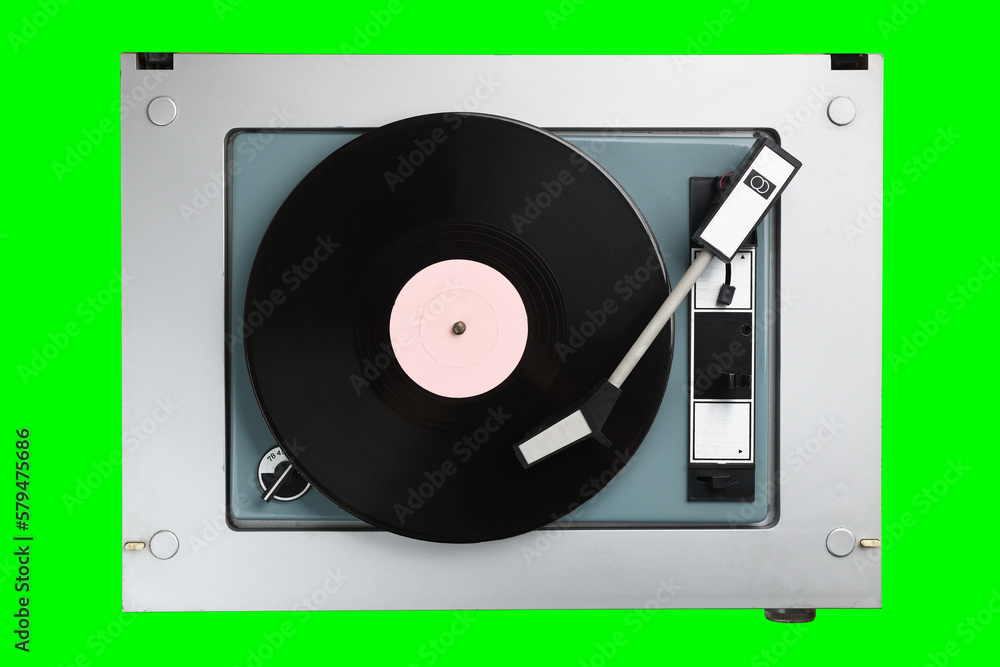 Obraz premium Vintage turntable with radio tuner isolated on green background