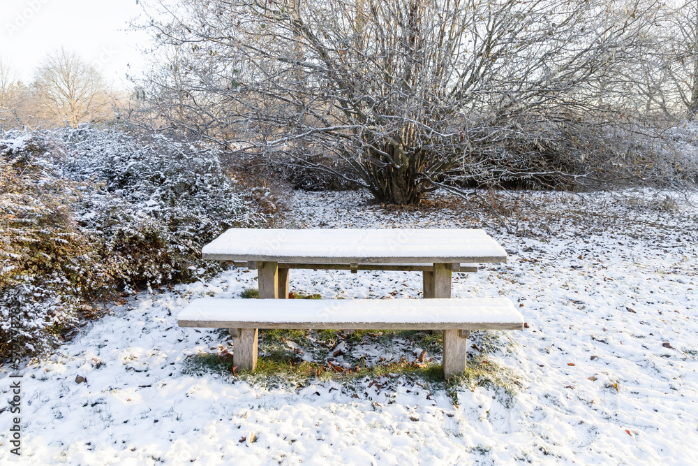 Wooden bench and table under the snow in the park in winter. High quality photo