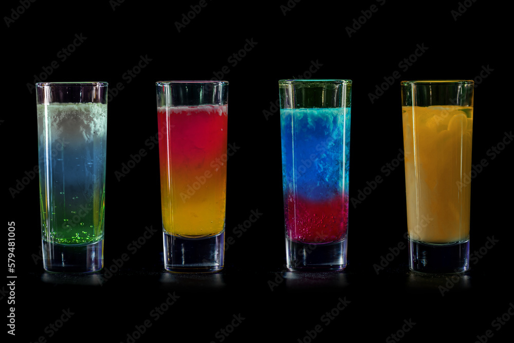Cocktails Party Shots and Shooters on bar counter in a restaurant, pub. Miniature mixed drinks. Alcoholic cooler beverage at nightclub on dark background Cocktails Party Shots and Shooters on bar counter in a restaurant, pub. Miniature mixed drinks. Alcoholic cooler beverage at nightclub on dark background