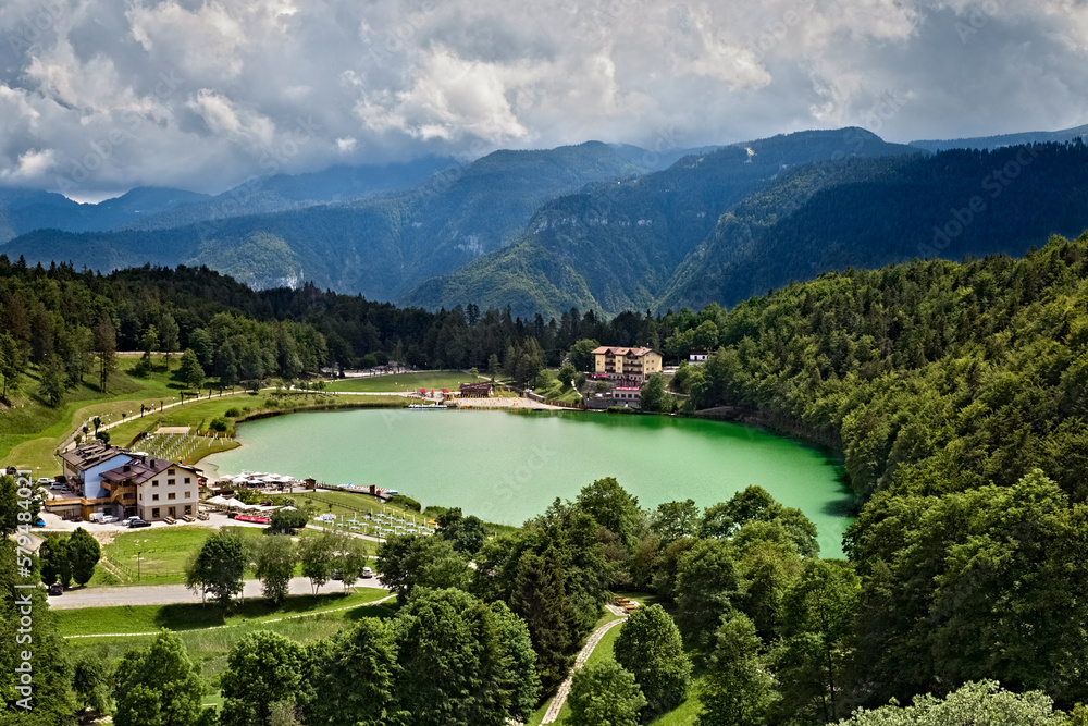 Lake Lavarone and the Venetian Pre-Alps in the background. Alpe Cimbra, Trentino, Italy.
