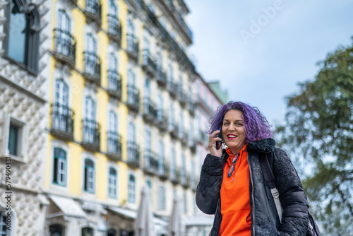 Cheerful Woman Talking On The Phone In The Street