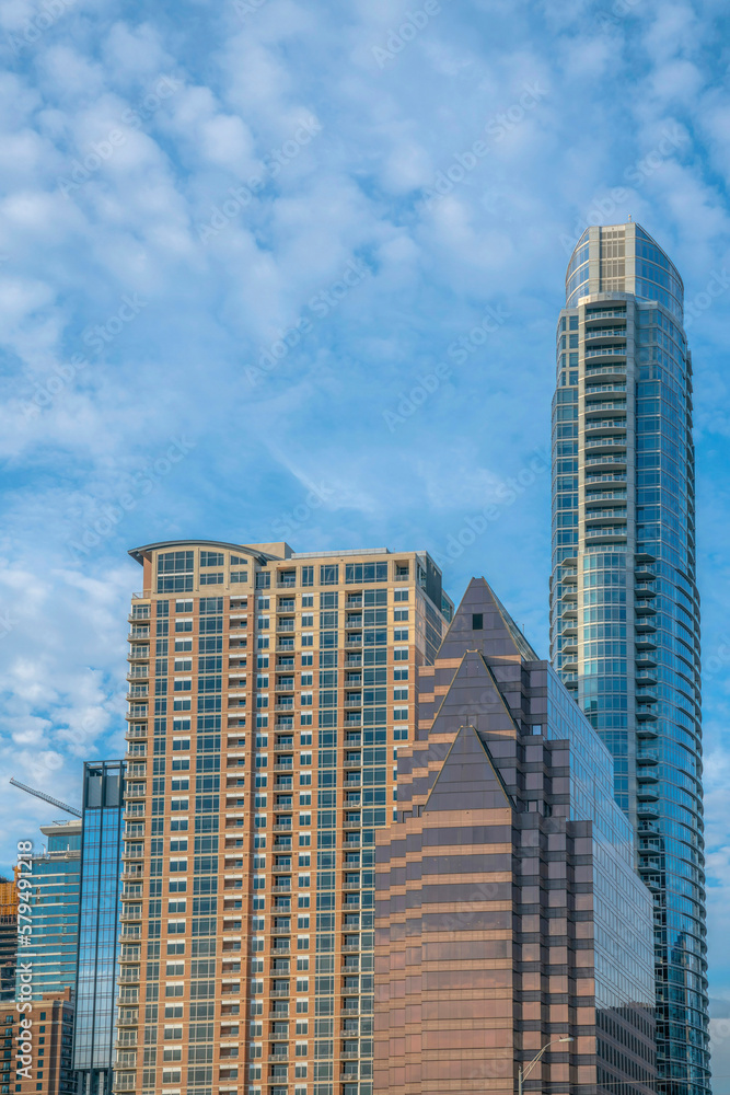 Modern apartments or flats in downtown Austin Texas with cloudy blue sky view. City skyline seen on a beautiful sunny day with contemporary architecture stuctures. Modern apartments or flats in downtown Austin Texas with cloudy blue sky view. City skyline seen on a beautiful sunny day with contemporary architecture stuctures.