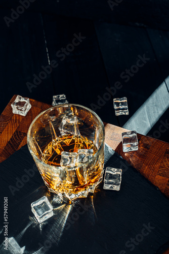 Wallpaper Mural Wiskey in a glass with the ice cubes on the reflective black surface. Bar drinking menu Torontodigital.ca